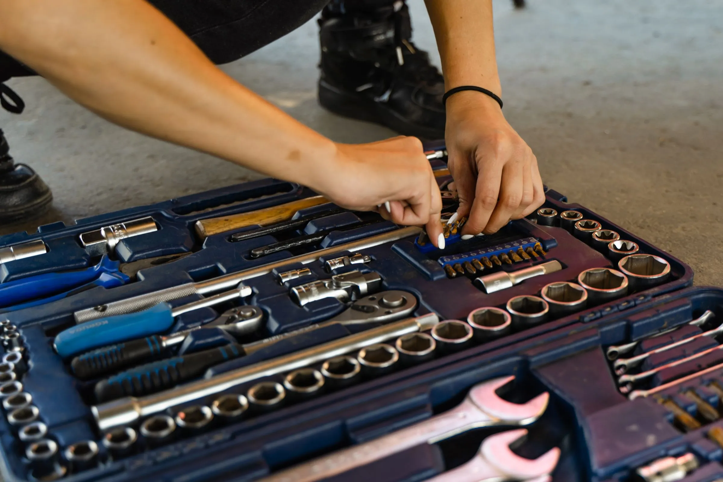 A technician choosing a socket from a neatly organized tool case.